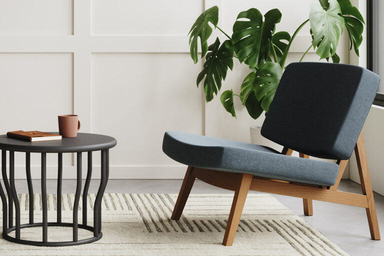 Two lounge chairs around a metal coffee table in a room with flat wall panelling.