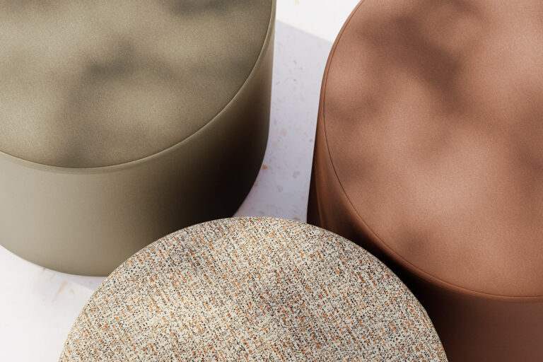 A top-down view of three-round ottomans covered in different colored textiles.